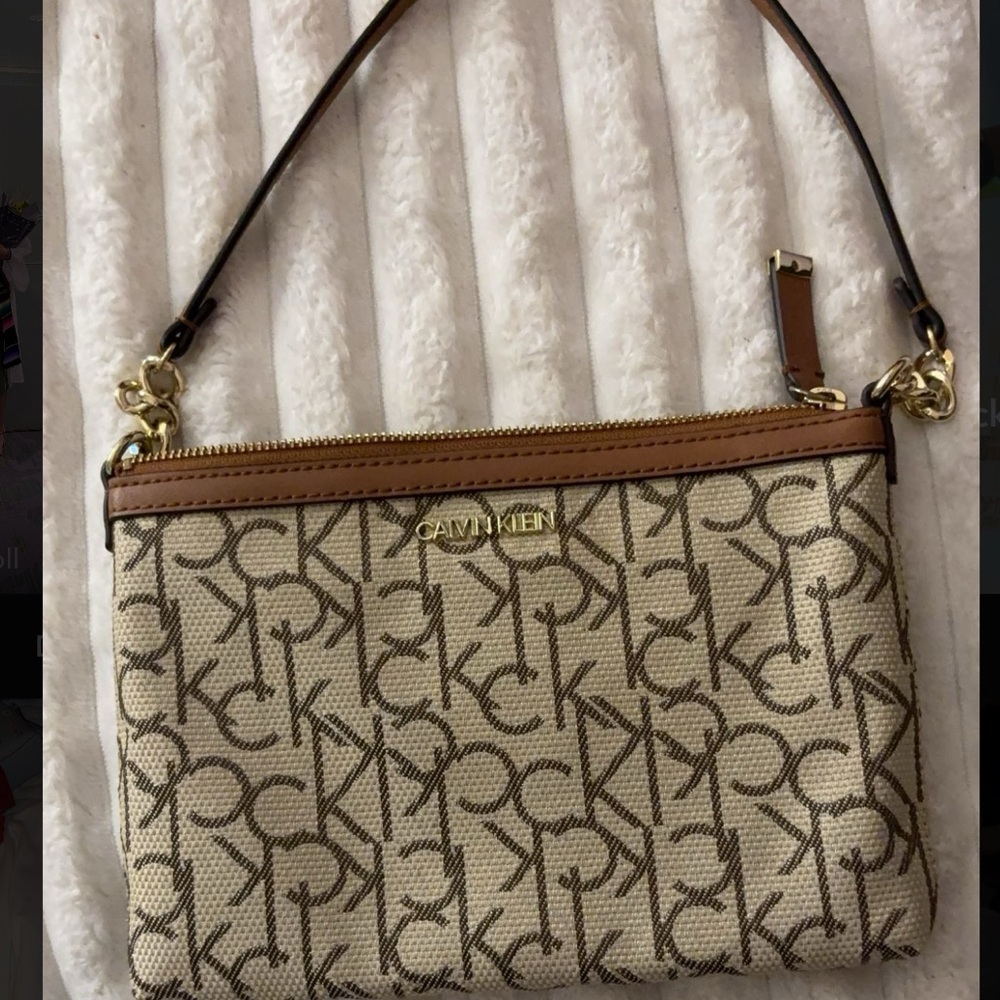 Calvin Klein Cream Crossbody Bag with Monogram Pattern and Leather Strap